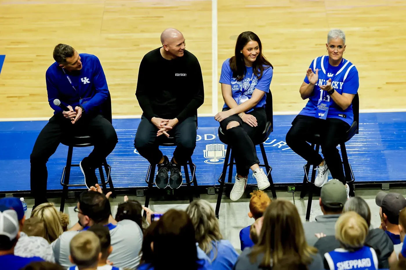 The Sheppard family seated together on stage in front of a crowd